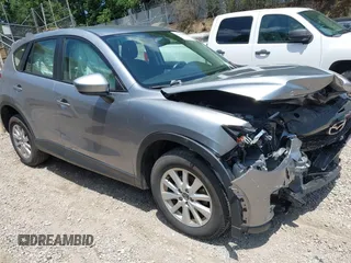 2014 Mazda CX-5 Sport with VIN JM3KE2BEXE0329303, listed as a IAAI auction lot 42556908 with 127,836 mi miles and . Bid and sale history available at DreamBid. Image 1.