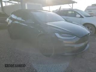 2023 Tesla Model X with VIN 7SAXCAE5XPF384061, listed as a Copart auction lot 86834084 with 6,974 mi miles and Salvage Title. Bid and sale history available at DreamBid. Image 4.