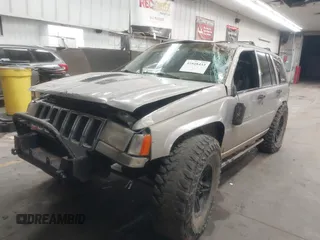 1998 Jeep Grand Cherokee Laredo with VIN 1J4GZ48Y9WC206957, listed as a IAAI auction lot 41848433 with 122,104 mi miles. Bid and sale history available at carsss.com. Image 2.