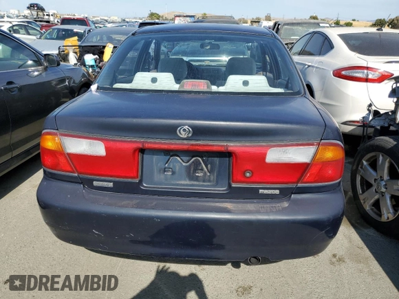 1997 Mazda Protege DX z VIN JM1BC1412V0157268, wystawiony jako Copart lot #61380564 z przebiegiem 85 356 mil mil oraz Szkoda całkowita • Salvage title. Historia ofert i sprzedaży dostępna na DreamBid. Obrazek 6.