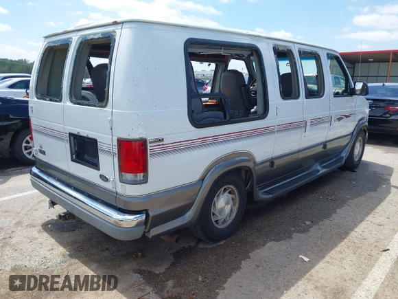 1999 Ford Econoline Cargo Recreational with VIN 1FDRE14L2XHA41059, listed as a IAAI auction lot 42067879 with 149,185 mi miles. Bid and sale history available at carsss.com. Image 4.