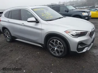 2021 BMW X1 xDrive28i with VIN WBXJG9C04M5T79810, listed as a IAAI auction lot 41471536 with 75,345 mi miles. Bid and sale history available at carsss.com. Image 1.