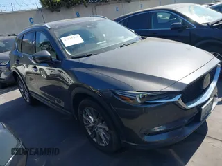 2020 Mazda CX-5 Grand Touring with VIN JM3KFADM3L1812649, listed as a IAAI auction lot 42575393 with 102,118 mi miles and . Bid and sale history available at DreamBid. Image 1.