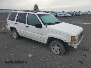1998 Jeep Grand Cherokee Laredo with VIN 1J4GZ48S1WC165851, listed as a Copart auction lot 84110044 with 306,484 mi miles and Salvage Title. Bid and sale history available at carsss.com. Image 4.