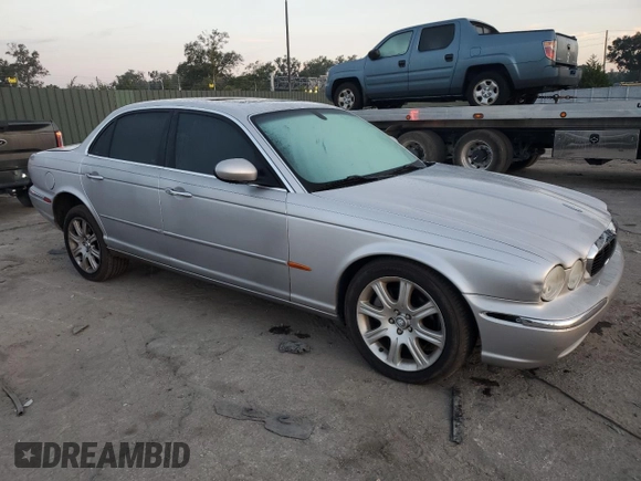 2004 Jaguar XJ with VIN SAJEA71C54SG01326, listed as a Copart auction lot 77449324 with 72,935 mi miles and Salvage Title. Bid and sale history available at carsss.com. Image 4.
