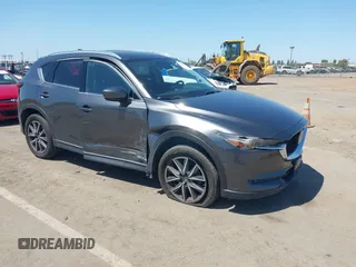 2017 Mazda CX-5 Grand Touring with VIN JM3KFADL6H0217850, listed as a IAAI auction lot 42033404 with 74,198 mi miles and . Bid and sale history available at carsss.com. Image 1.