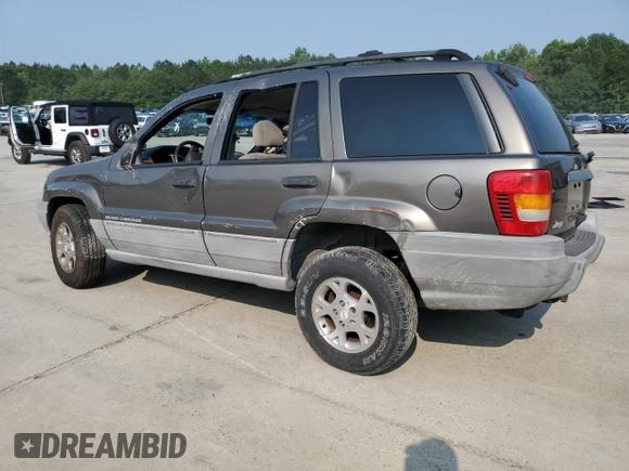 1999 Jeep Grand Cherokee Laredo with VIN 1J4G258S9XC731752, listed as a Copart auction lot 58601555 with 245,284 mi miles and Salvage title. Bid and sale history available at DreamBid. Image 2.