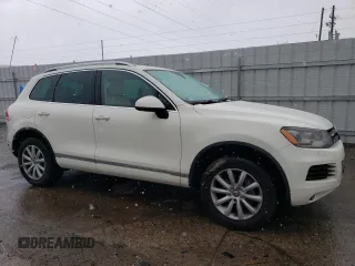 2011 Volkswagen Touareg Sport with VIN WVGFF9BP8BD002982, listed as a Copart auction lot 53958555 with 156,742 mi miles and Salvage Title. Bid and sale history available at DreamBid. Image 4.
