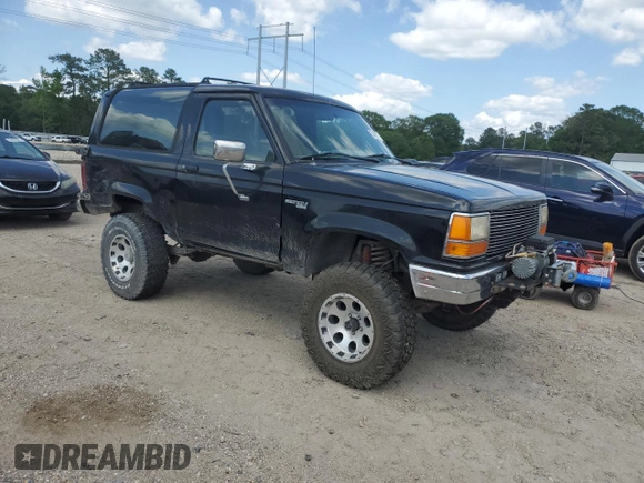 1990 Ford Bronco with VIN 1FMCU14T9LUA15536, listed as a Copart auction lot 54391815 with 319,124 mi miles and Salvage title. Bid and sale history available at DreamBid. Image 4.