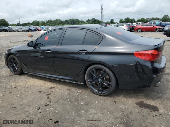 2018 BMW 5 Series M550i xDrive with VIN WBAJB9C51JB286700, listed as a Copart auction lot 64681004 with 76,304 mi miles and Salvage Title. Bid and sale history available at carsss.com. Image 2.