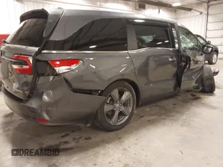 2021 Honda Odyssey Touring with VIN 5FNRL6H82MB025923, listed as a IAAI auction lot 42104290 with 61,178 mi miles and . Bid and sale history available at DreamBid. Image 4.