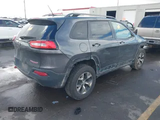 2015 Jeep Cherokee Trailhawk with VIN 1C4PJMBS9FW785545, listed as a IAAI auction lot 41573197 with 124,304 mi miles. Bid and sale history available at carsss.com. Image 4.