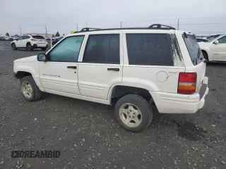 1998 Jeep Grand Cherokee Laredo with VIN 1J4GZ48S1WC165851, listed as a Copart auction lot 84110044 with 306,484 mi miles and Salvage Title. Bid and sale history available at carsss.com. Image 2.