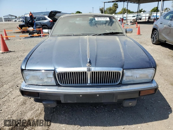 1992 Jaguar XJ with VIN SAJHY174XNC649368, listed as a Copart auction lot 50191454 with 99,553 mi miles and Salvage Title. Bid and sale history available at DreamBid. Image 5.