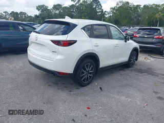 2018 Mazda CX-5 Touring z VIN JM3KFACM6J1419663, wystawiony jako IAAI lot #41879677 z przebiegiem 115 224 mil mil oraz . Historia ofert i sprzedaży dostępna na DreamBid. Obrazek 4.