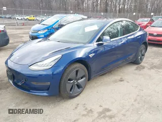 2019 Tesla Model 3 Mid Range with VIN 5YJ3E1EA5KF299589, listed as a IAAI auction lot 41709733 with 50,256 mi miles and . Bid and sale history available at DreamBid. Image 2.