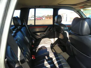 1999 Jeep Grand Cherokee Limited with VIN 1J4GW68N8XC770305, listed as a IAAI auction lot 41720558 with 206,180 mi miles. Bid and sale history available at carsss.com. Image 8.