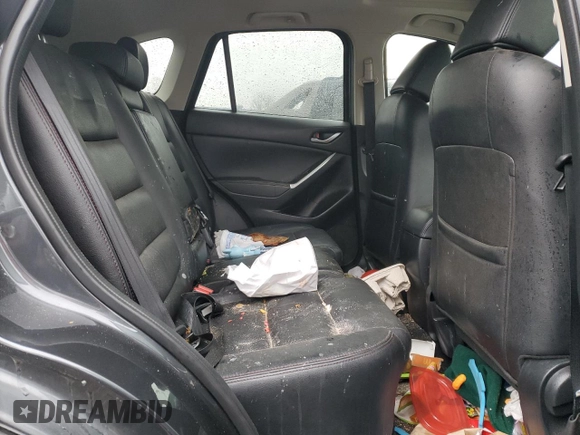 2016 Mazda CX-5 Grand Touring z VIN JM3KE2DY9G0687261, wystawiony jako Copart lot #52865415 z przebiegiem Nie podano mil oraz Szkoda całkowita • Salvage title. Historia ofert i sprzedaży dostępna na DreamBid. Obrazek 11.