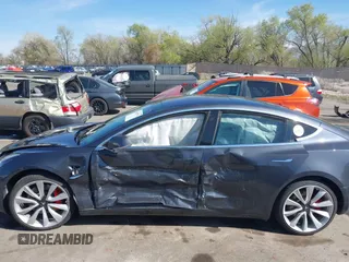 2018 Tesla Model 3 Long Range Battery with VIN 5YJ3E1EBXJF055203, listed as a IAAI auction lot 42019770 with 57,379 mi miles and . Bid and sale history available at DreamBid. Image 14.