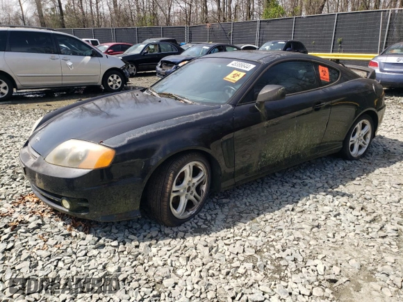 2003 Hyundai Tiburon GT z VIN KMHHN65F13U084620, wystawiony jako Copart lot #46880185 z przebiegiem Nie podano mil oraz Nie do naprawy • Non repairable. Historia ofert i sprzedaży dostępna na DreamBid. Obrazek 1.