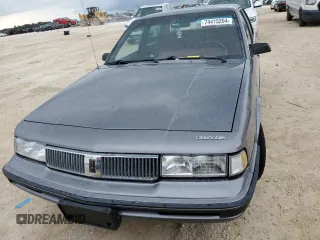 1992 Oldsmobile Cutlass z VIN 1G3AL54N4N6438104, wystawiony jako Copart lot #74415204 z przebiegiem 118 459 mil mil oraz Szkody całkowita. Historia ofert i sprzedaży dostępna na DreamBid. Obrazek 5.
