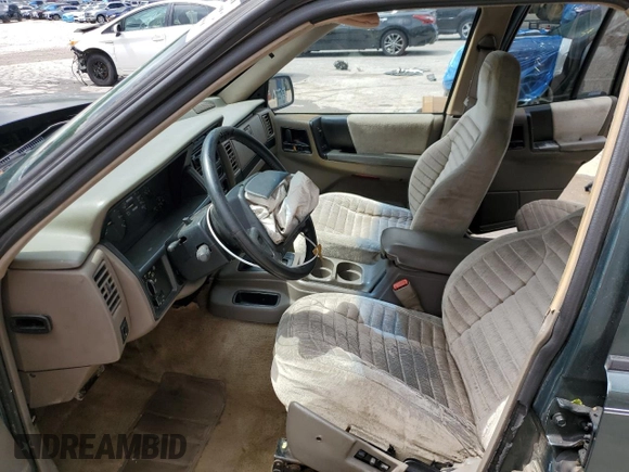 1995 Jeep Grand Cherokee Laredo with VIN 1J4FX58S8SC773884, listed as a Copart auction lot 56572555 with 424,126 mi miles and Salvage title. Bid and sale history available at DreamBid. Image 7.