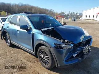 2021 Mazda CX-5 Touring z VIN JM3KFBCM0M0496397, wystawiony jako IAAI lot #42053603 z przebiegiem 176 328 mil mil oraz . Historia ofert i sprzedaży dostępna na DreamBid. Obrazek 1.