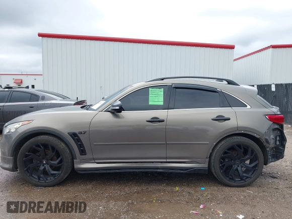 2014 Infiniti QX70 z VIN JN8CS1MU3EM451745, wystawiony jako IAAI lot #42203922 z przebiegiem 144 990 mil mil oraz . Historia ofert i sprzedaży dostępna na DreamBid. Obrazek 14.