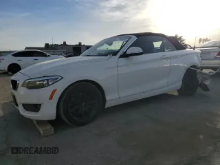 2015 BMW 2 Series 228i with VIN WBA1K5C57FV242909, listed as a Copart auction lot 77490994 with 55,099 mi miles and Salvage Title. Bid and sale history available at carsss.com. Image 1.