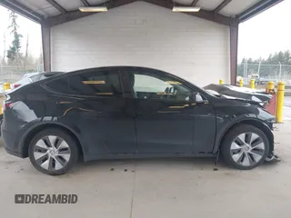 2023 Tesla Model Y Long Range with VIN 7SAYGDEE0PF909610, listed as a IAAI auction lot 41906081 with 20,656 mi miles and . Bid and sale history available at DreamBid. Image 14.