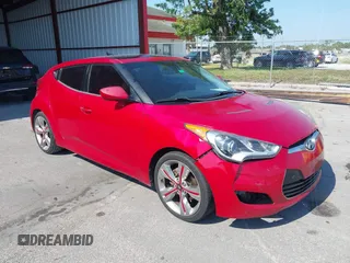 2012 Hyundai Veloster w/Gray Int z VIN KMHTC6AD0CU040970, wystawiony jako IAAI lot #42174672 z przebiegiem 142 310 mil mil oraz . Historia ofert i sprzedaży dostępna na DreamBid. Obrazek 1.