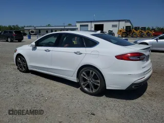2020 Ford Fusion Titanium с VIN 3FA6P0K99LR174094, выставлен на аукционе Copart как лот 52583435 с пробегом 98 389 миль миль и Списание • Salvage title. История ставок и продаж доступна на DreamBid. Изображение 2.