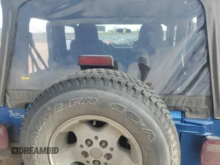 2003 Jeep Wrangler Sport z VIN 1J4FA49S53P350281, wystawiony jako Copart lot #56634005 z przebiegiem 158 974 mil mil oraz Szkoda całkowita • Salvage title. Historia ofert i sprzedaży dostępna na DreamBid. Obrazek 10.