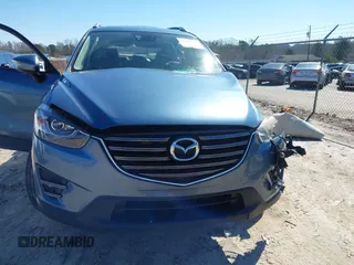 2016 Mazda CX-5 Grand Touring with VIN JM3KE2DY2G0715272, listed as a IAAI auction lot 41590492 with 134,176 mi miles. Bid and sale history available at carsss.com. Image 13.