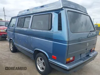 1989 Volkswagen Vanagon with VIN WV2YB0252KH059286, listed as a IAAI auction lot 42137080 with 130,604 mi miles and . Bid and sale history available at DreamBid. Image 3.
