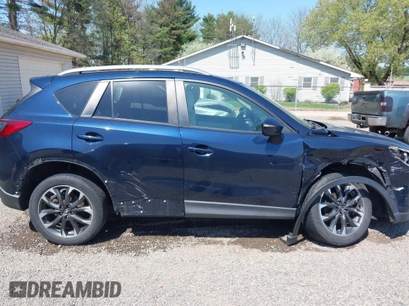 2016 Mazda CX-5 Grand Touring with VIN JM3KE4DY5G0681369, listed as a IAAI auction lot 42102805 with 128,182 mi miles and . Bid and sale history available at DreamBid. Image 13.