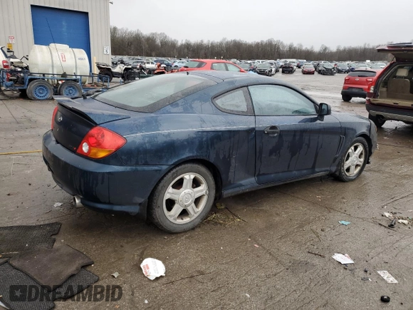 2003 Hyundai Tiburon GT z VIN KMHHN65F13U068658, wystawiony jako Copart lot #81799404 z przebiegiem 163 148 mil mil oraz Szkoda całkowita • Salvage title. Historia ofert i sprzedaży dostępna na DreamBid. Obrazek 3.
