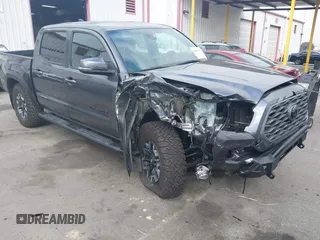2021 Toyota Tacoma SR z VIN 3TMCZ5AN9MM397611, wystawiony jako IAAI lot #41467705 z przebiegiem 65 191 mil mil oraz . Historia ofert i sprzedaży dostępna na DreamBid. Obrazek 1.