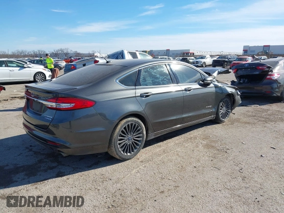 2017 Ford Fusion Hybrid Titanium z VIN 3FA6P0RU0HR314681, wystawiony jako IAAI lot #41288256 z przebiegiem 174 027 mil mil oraz . Historia ofert i sprzedaży dostępna na DreamBid. Obrazek 4.