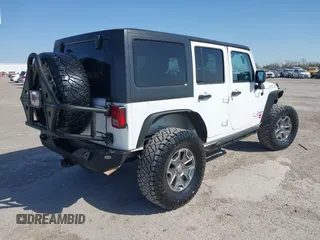 2014 Jeep Wrangler Unlimited Rubicon with VIN 1C4BJWFG1EL167423, listed as a IAAI auction lot 41861109 with 104,669 mi miles. Bid and sale history available at carsss.com. Image 4.