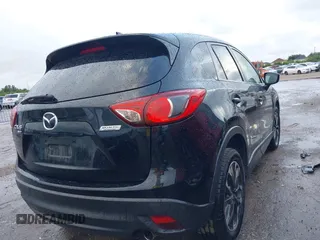 2016 Mazda CX-5 Grand Touring z VIN JM3KE4DY9G0605489, wystawiony jako IAAI lot #42085160 z przebiegiem 160 338 mil mil oraz . Historia ofert i sprzedaży dostępna na DreamBid. Obrazek 4.