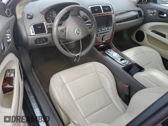 2010 Jaguar XK with VIN SAJWA4GB4ALB37114, listed as a Copart auction lot 77673824 with 99,999 mi miles and Salvage Title. Bid and sale history available at carsss.com. Image 8.