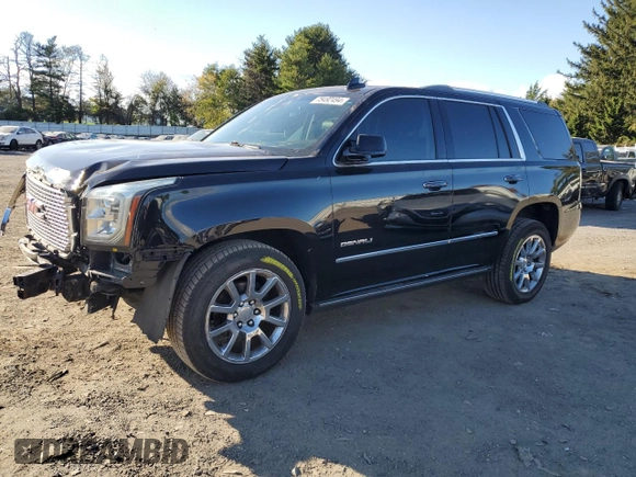 2016 GMC Yukon Denali with VIN 1GKS1CKJXGR329103, listed as a Copart auction lot 75492494 with 124,374 mi miles and Salvage Title. Bid and sale history available at carsss.com. Image 1.