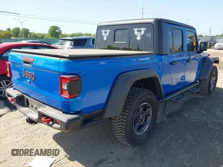 2023 Jeep Gladiator Rubicon with VIN 1C6JJTBG3PL581023, listed as a IAAI auction lot 41963931 with 15,023 mi miles and . Bid and sale history available at DreamBid. Image 4.