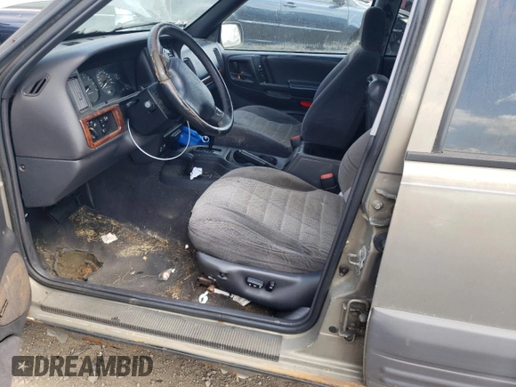 1997 Jeep Grand Cherokee Laredo z VIN 1J4GZ58S4VC502596, wystawiony jako Copart lot #88255865 z przebiegiem Nie podano mil oraz Nie do naprawy • Non repairable. Historia ofert i sprzedaży dostępna na DreamBid. Obrazek 7.