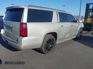 2015 Chevrolet Suburban LT z VIN 1GNSCJKC1FR608117, wystawiony jako IAAI lot #41641560 z przebiegiem 163 770 mil mil oraz . Historia ofert i sprzedaży dostępna na DreamBid. Obrazek 4.