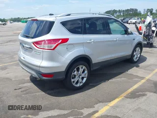 2014 Ford Escape Titanium with VIN 1FMCU0JX7EUA28824, listed as a IAAI auction lot 42065325 with 107,761 mi miles. Bid and sale history available at carsss.com. Image 4.