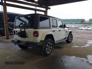 2018 Jeep Wrangler Unlimited Sahara with VIN 1C4HJXEG3JW116404, listed as a IAAI auction lot 42152506 with 57,727 mi miles and . Bid and sale history available at DreamBid. Image 4.
