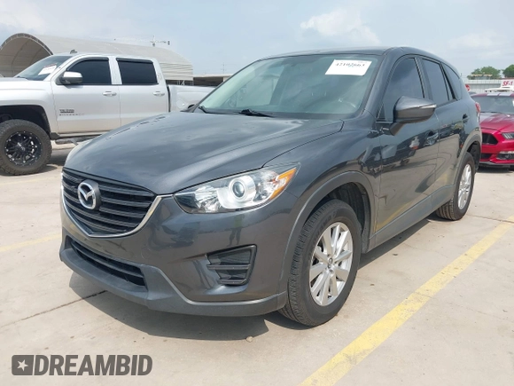 2016 Mazda CX-5 Sport with VIN JM3KE4BY8G0921243, listed as a IAAI auction lot 42102663 with 111,960 mi miles and . Bid and sale history available at DreamBid. Image 2.