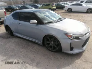2014 Scion tC with VIN JTKJF5C77E3077357, listed as a IAAI auction lot 41698220 with 129,153 mi miles. Bid and sale history available at carsss.com. Image 1.